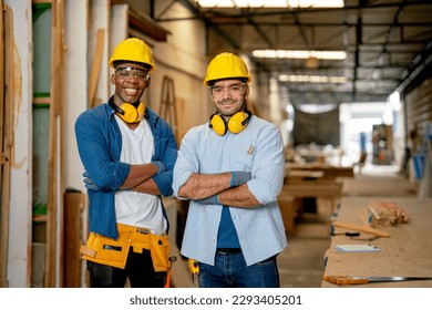 Portrait of African American and Caucasian carpenter man stand with arm crossed and smiling also look at camera in wood factory workplace. - Powered by Shutterstock