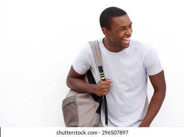 Portrait of an african american college student laughing with bag on white background 