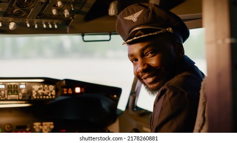 Portrait Of African American Copilot Helping To Fly Airplane, Using Dashboard Power Buttons And Power Engine To Takeoff. Aviation Command On Control Panel With Aerial Navigation.