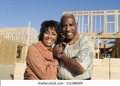 Portrait Of African American Couple In Front Of New Home Still Under Construction