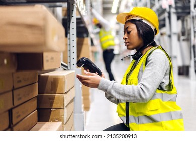 Portrait of african american engineer woman scanning package with barcode scanner check goods in transportation and distribution in warehouse.logistic Industrial and business export - Powered by Shutterstock