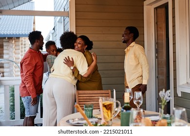 Portrait of African American family embracing outdoors welcoming guests for house party - Powered by Shutterstock