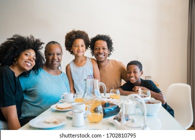 Portrait Of African American Family Having Breakfast Together At Home. Family And Lifestyle Concept.