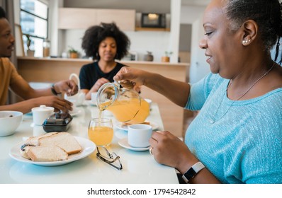 Portrait Of African American Family Having Breakfast Together At Home. Family And Lifestyle Concept.