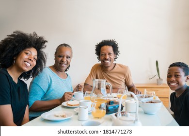 Portrait Of African American Family Having Breakfast Together At Home. Family And Lifestyle Concept.