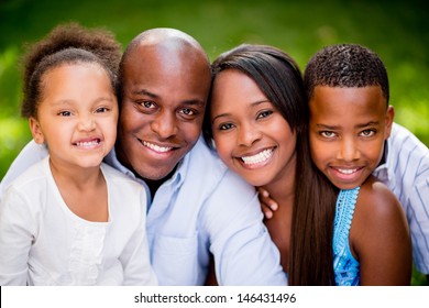 Portrait Of An African American Family Looking Very Happy Outdoors