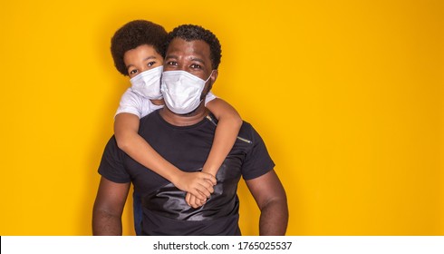 Portrait Of  African American Father With Toddler Son Using Mask. Father And Son Wearing Mask To Protect Covid 19, Quarantine. Stay At Home Concept. Fathers Day! 