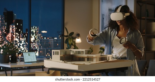 Portrait Of African American Female Architect Or Student Using A Virtual Reality VR Headset To Work On A House Project Late At Night, Preparing For Presentation With A Client