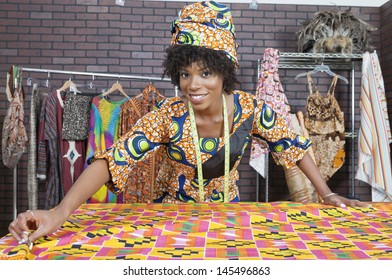 Portrait Of An African American Female Fashion Designer Working On A Pattern Cloth