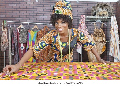 Portrait Of An African American Female Fashion Designer Working On A Pattern Cloth