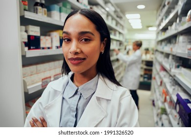 Portrait Of African American Female Working In Chemist In Labcoat With Folded Hands Looking At Camera