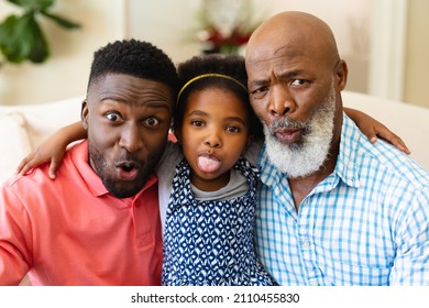 Portrait of african american grandfather, father and granddaughter making silly faces at home. family, love and togetherness concept, unaltered.