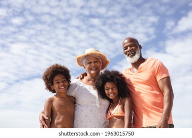 Portrait of african american grandparents and grandchildren smiling at the beach. travel vacation summer beach concept - Powered by Shutterstock