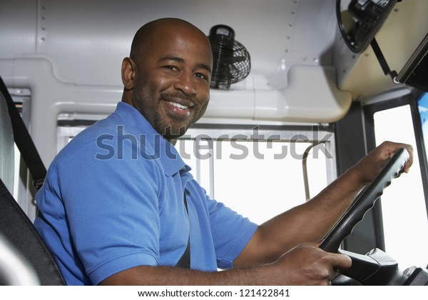 Portrait of an African American handsome bus\
driver smiling