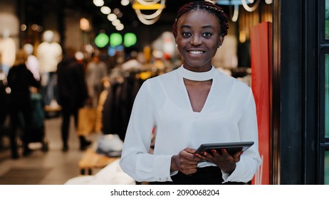 Portrait African American Happy Smiling Glad Successful Salesperson Woman Consultant In Clothing Store Shopkeeper Boutique Employee Holding Digital Tablet Looking At Camera With Smile, Discount Sales