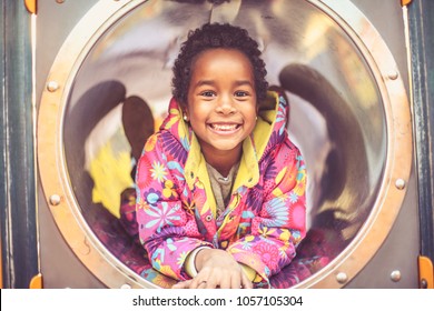 Portrait Of African American Little Girl On Playground. Close Up.