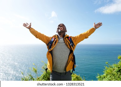 Portrait Of African American Male Hiker With Backpack And Arms Open 