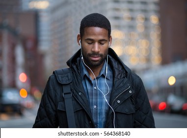 Portrait Of African American Man Listening To Music And Taking In Before Work. Photographed In NYC 2016.