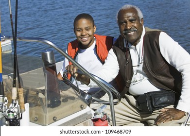 Portrait Of An African American Man Sitting With Grandson In A Boat