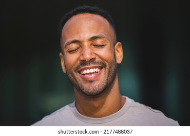 Portrait Of African American Man Smiling With His Eyes Closed