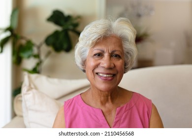Portrait von afroamerikanischer Seniorin, die auf dem Sofa zu Hause sitzt. Menschen und Emotionen Konzept, unverändert.