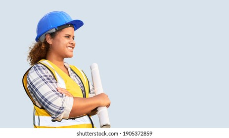 Portrait of African American woman architect wearing a vest and helmet on isolated background.