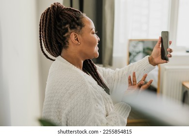 Portrait African american woman making video call in bedroom - social networks and connection - Shutterstock ID 2255854815