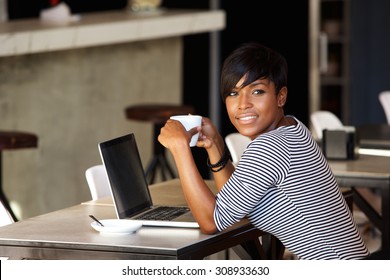 Portrait Of An African American Woman Relaxing At Cafe With Laptop And Coffee