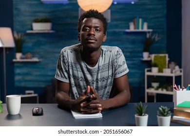Portrait Of African American Young Employee Having Online Videocall Meeting Confrence With Remote Businessman Discussing Business Information. Black Guy At Desk In Living Room. Teleconference Call