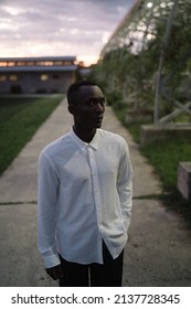 Portrait Of African Black Man Outdoors In Village At Night While Thinking