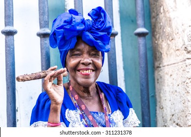 Portrait Of African Cuban Woman Smoking Cigar In Havana, Cuba