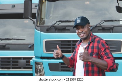 Portrait African Male Happy Smiling Confident Positive Near Lorry. Young Man Plaid Shirt Owner Truck Driver In Business Long Transport Thumbs Up Satisfied Service Commercial Driving License Training.