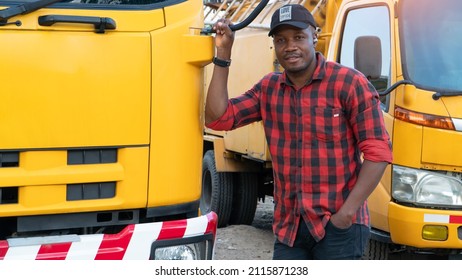 Portrait African Men Happy Smiling Confident Positive Standing Near Lorry. Young Man Owner Truck Driver In Business Long Transport In Plaid Shirt Smile Satisfied With Service Experience Car Insurance.