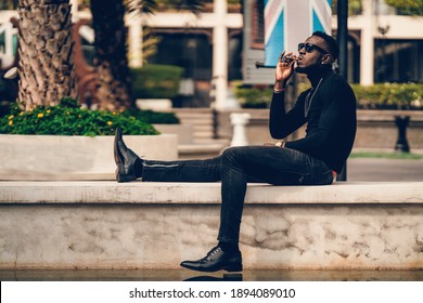 Portrait Of African Model Smoking Cigar And Posing For Photography.