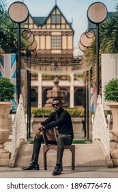 Portrait Of African Model Smoking Cigar And Posing For Photography.