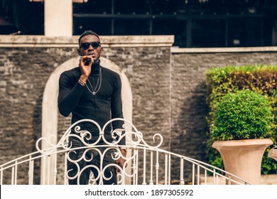 Portrait Of African Model Smoking Cigar And Posing For Photography.