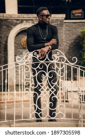 Portrait Of African Model Smoking Cigar And Posing For Photography.