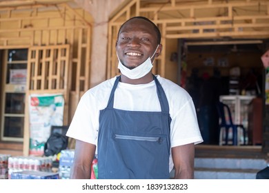 Portrait Of An African Small Business Owner Wearing A Face Mask In Front Of His Store And Smiling