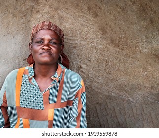 Portrait Of An African Woman Sitting Next To The Wall In A Village In Botswana