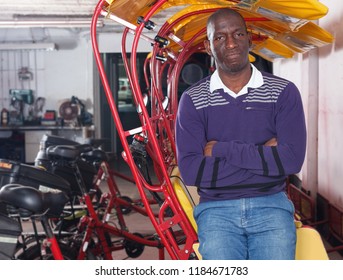 Portrait of African-American young man  rickshaw cycle driver 