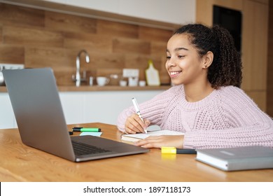 Portrait of afro american teen girl studying online using app, watching web conference, e learning distance, training course and writing online lecture by videocall. Work at home at quarantine. 