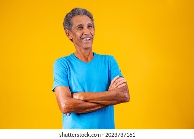 Portrait Of Afro Elderly Man With Arms Crossed Smiling At The Camera.