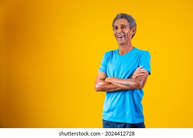 Portrait Of Afro Elderly Man With Arms Crossed Smiling At The Camera.