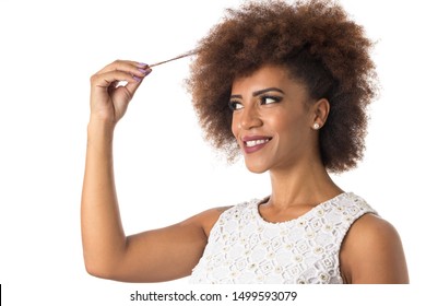 Portrait of afro hair black brazilian girl smiling cheerfully and holding hair. Concept of hair care. Standing against white background.