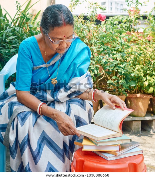 portrait-aged-indian-bengali-woman-reading-stock-photo-1830888668