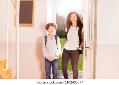 Portrait of age-diverse children, smiling boy and girl with backpacks, coming back home from school - Powered by Shutterstock