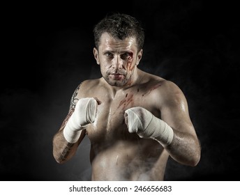 Portrait of aggressiv boxer in blood