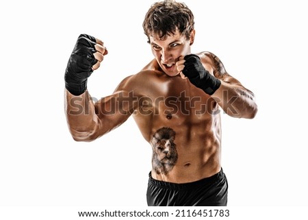 Portrait of aggressive boxer training and practicing uppercut. Isolated on white studio background. Concept of sport, healthy lifestyle. Red sportswear 