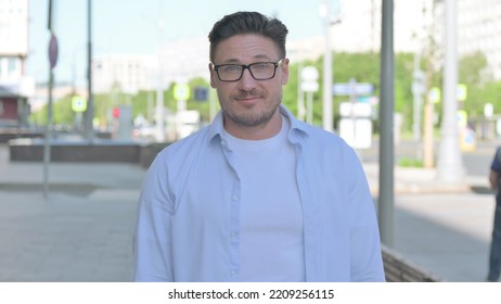 Portrait Of Agree Man Shaking Head In Approval Outdoor