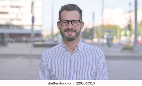 Portrait Of Agree Young Adult Man Shaking Head In Approval Outdoor